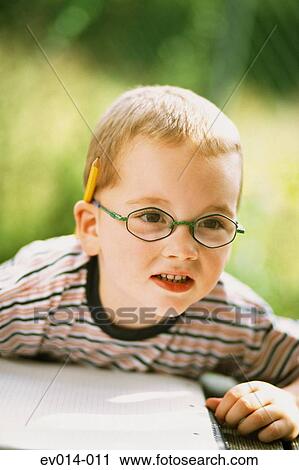 Stock Image - Boy at homework. Fotosearch