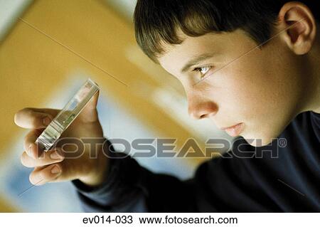 Stock Image - Boy examining petri dish. Fotosearch