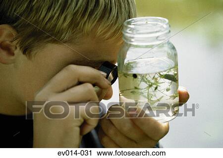 Stock Image - Boy with water sample. Fotosearch
