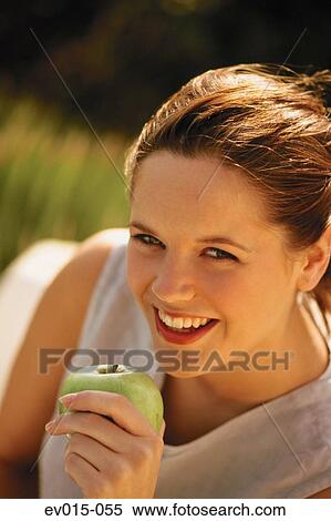 Stock Photography - Girl eating apple. Fotosearch