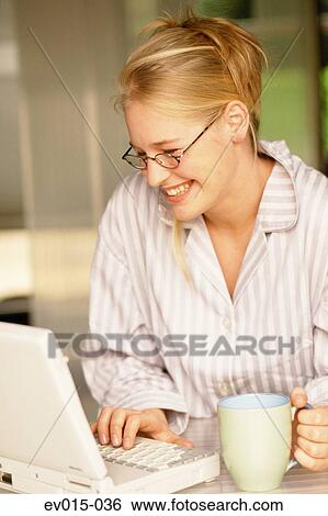 Girl working on laptop View Large Photo Image Stock Photograph - Girl working on laptop. Fotosearch