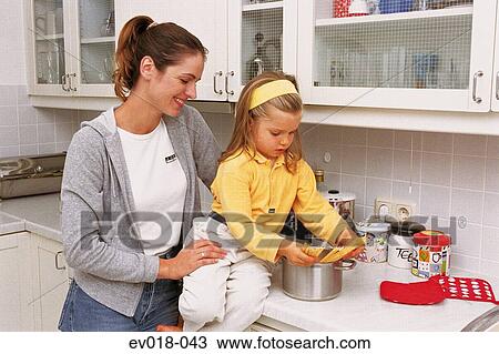 Mother and daughter in kitchen View Large Photo Image Stock Image - Mother and daughter in kitchen. Fotosearch