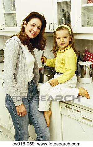 Mother and daughter in kitchen View Large Photo Image Stock Photo - Mother and daughter in kitchen. Fotosearch