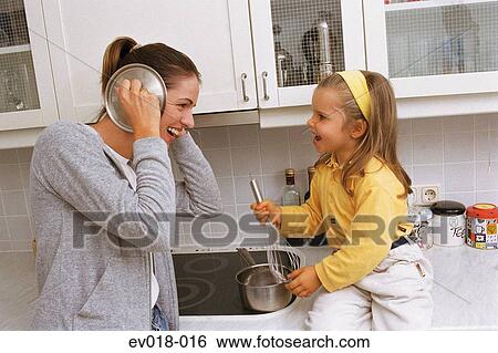 Mother and daughter in kitchen View Large Photo Image Stock Photograph - Mother and daughter in kitchen. Fotosearch