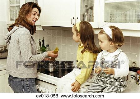 Mother and daughters in kitchen View Large Photo Image Stock Photo - Mother and daughters in kitchen. Fotosearch