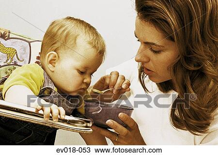 Mother feeding baby View Large Photo Image Stock Image - Mother feeding baby. Fotosearch
