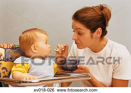 Mother feeding baby View Large Photo Image Stock Photograph - Mother feeding baby. Fotosearch