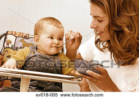 Mother feeding baby View Large Photo Image Stock Photography - Mother feeding baby. Fotosearch