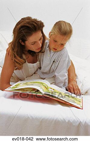 Stock Image - Mother reading to child. Fotosearch