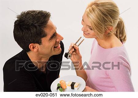 Couple eating sushi View Large Photo Image Stock Image - Couple eating sushi. Fotosearch