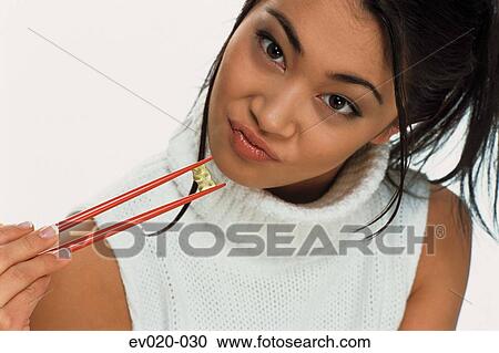 Girl eating sushi View Large Photo Image Stock Image - Girl eating sushi. Fotosearch