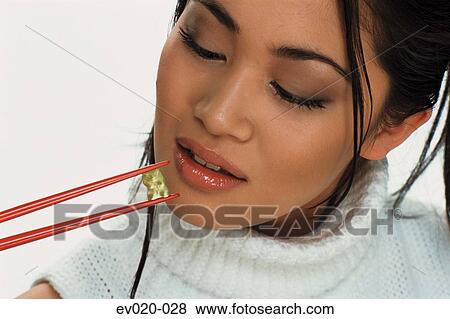 Girl eating sushi View Large Photo Image Stock Photo - Girl eating sushi. Fotosearch