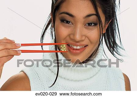 Girl eating sushi View Large Photo Image Stock Photo - Girl eating sushi. Fotosearch