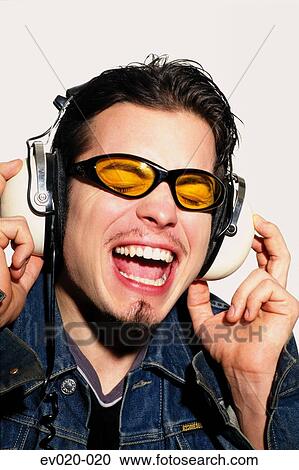 Stock Image - Man singing along to music. Fotosearch
