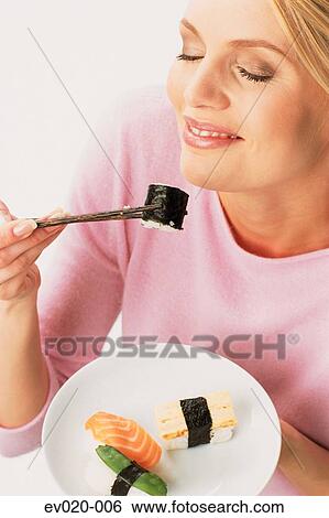 Woman eating sushi View Large Photo Image Stock Photograph - Woman eating sushi. Fotosearch