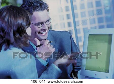 Stock Image - Business couple in office. Fotosearch