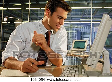 Businessman at his desk View Large Photo Image Picture - Businessman at his desk. Fotosearch