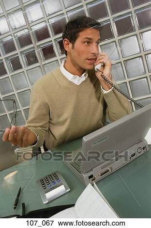 Businessman talking on phone View Large Photo Image Stock Photo - Businessman talking on phone. Fotosearch