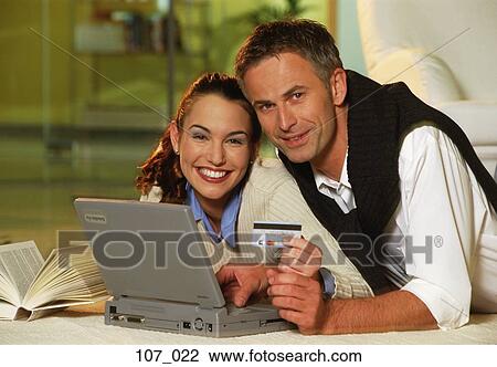 Stock Image - Couple Internet-shopping. Fotosearch