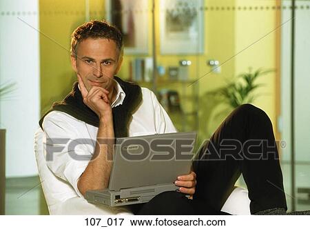Man with laptop View Large Photo Image Stock Photo - Man with laptop. Fotosearch