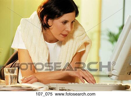 Stock Photography - Woman at computer. Fotosearch