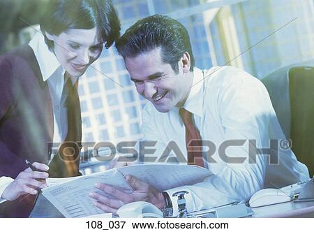 Stock Photo - Business people studying document. Fotosearch