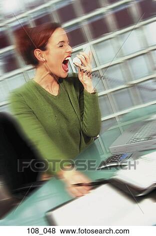 Woman screaming down the phone View Large Photo Image Stock Photo - Woman screaming down the phone. Fotosearch