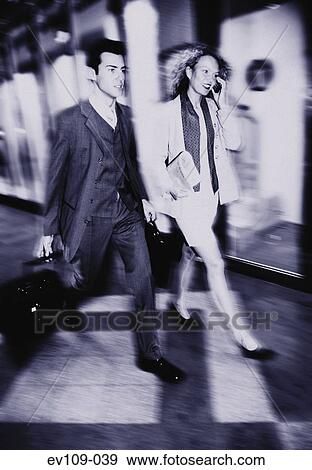 Business couple on the move View Large Photo Image Stock Photo - Business couple on the move. Fotosearch