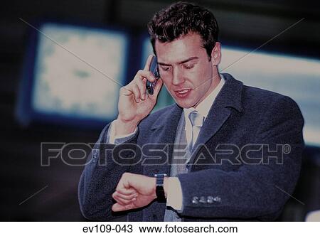 Stock Image - Businessman checking time. Fotosearch