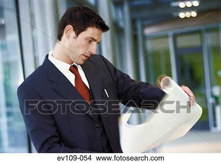 Businessman studying document View Large Photo Image Picture - Businessman studying document. Fotosearch