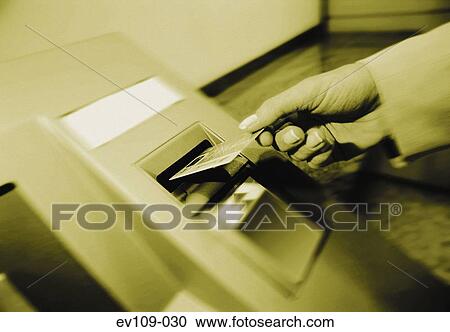 Stock Image - Cash machine in use. Fotosearch