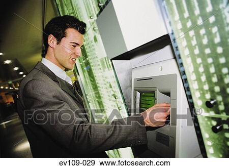 Stock Photo - Man withdrawing cash. Fotosearch