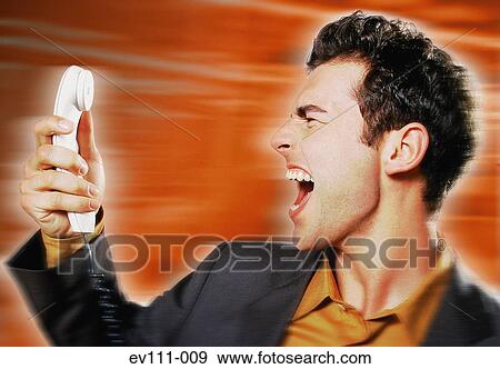 Stock Photo - Man shouting into phone. Fotosearch