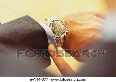 Checking time View Large Photo Image Stock Photo - Checking time. Fotosearch