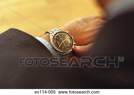 Stock Photography - Checking time. Fotosearch