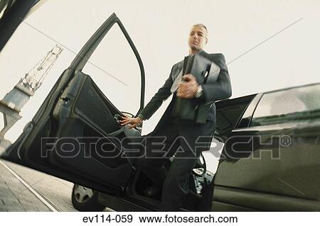 Man getting out of car View Large Photo Image Stock Photo - Man getting out of car. Fotosearch