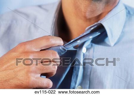 Stock Image - Loosening the tie. Fotosearch
