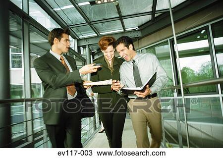 Stock Image - Business people in corridor. Fotosearch