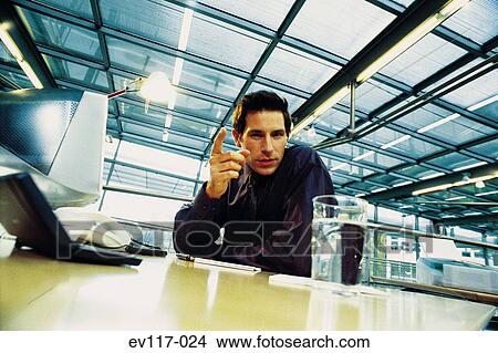 Businessman at his desk View Large Photo Image Picture - Businessman at his desk. Fotosearch