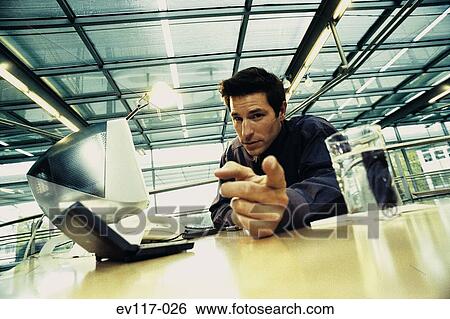 Businessman at his desk View Large Photo Image Stock Photograph - Businessman at his desk. Fotosearch