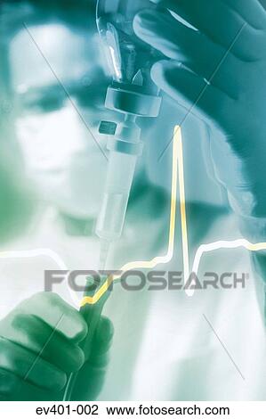 Stock Image - Nurse checking drip. Fotosearch