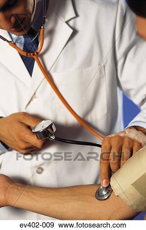 Checking blood pressure View Large Photo Image Stock Photo - Checking blood pressure. Fotosearch