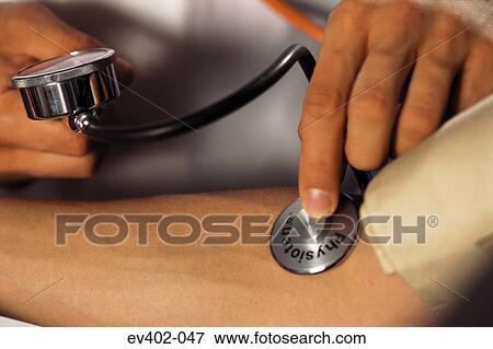 Stock Photo - Checking blood pressure. Fotosearch