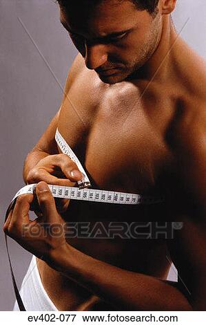 Man measuring chest View Large Photo Image Stock Photo - Man measuring chest. Fotosearch