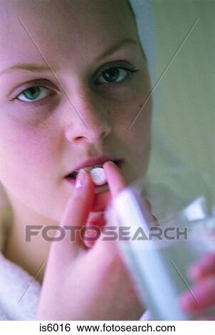 Girl taking tablet View Large Photo Image Stock Photograph - Girl taking tablet. Fotosearch