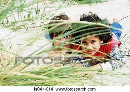 Boys playing hide-and-seek View Large Photo Image Picture - Boys playing hide-and-seek . Fotosearch