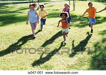 Stock Image - Children running in a park . Fotosearch