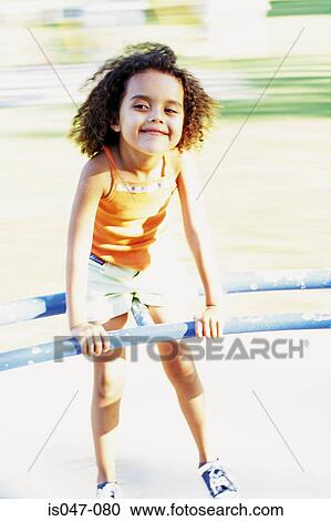 Stock Image - Girl on a roundabout. Fotosearch