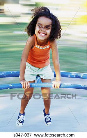 Girl on a roundabout View Large Photo Image Stock Photo - Girl on a roundabout. Fotosearch