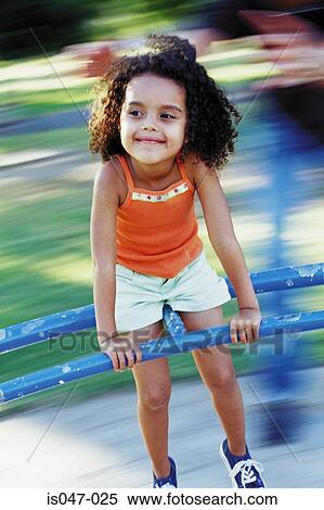 Girl on a roundabout View Large Photo Image Stock Photography - Girl on a roundabout. Fotosearch